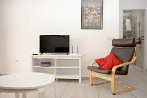 a living room with a chair and a tv at Casa Melera in Costa Teguise