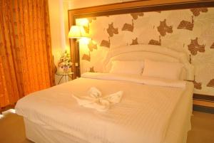 Postel nebo postele na pokoji v ubytování O.U.M. Hotel - โรงแรมโอยูเอ็ม