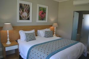 a bedroom with a large white bed with pillows at Pearl Valley Suite 504 in Simondium