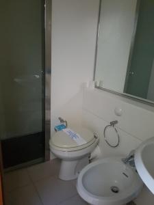 a bathroom with a toilet and a sink and a shower at Residence I Boboli BC in Punta Ala