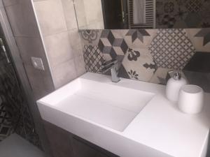 a white sink in a bathroom with a mirror at Palazzo Carasi Apartments in Cremona