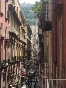 a city street with people walking down the street at B&B Il Balconcino a Santa Chiara in Naples
