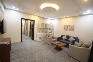 a living room with a couch and a table at Ra'af Abha lilwahadat alsakaniih راف أبها للوحدات السكنية in Abha
