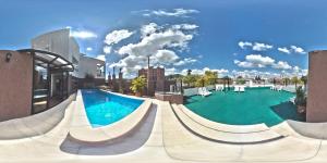 a large swimming pool with a slide in a building at Hotel Astur in Salta