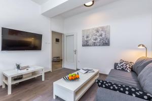 a living room with a couch and a table at Stay IN apartment in Rijeka