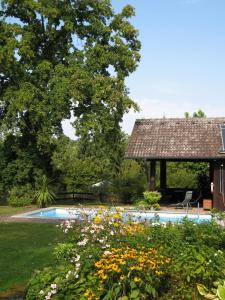 a garden with a swimming pool and a gazebo at Ferienwohnung Hubner in Bernlohe