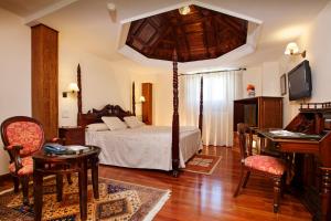 a bedroom with a bed and a piano at Finca Eslava in Antequera