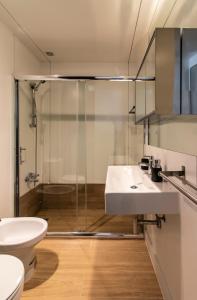 a bathroom with a shower and a sink and a toilet at BmyGuest - Oura Beach Studio I in Albufeira