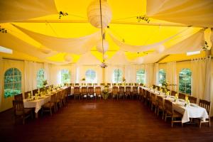 a large room with tables and chairs in it at Rancho Ślężański Młyn in Szczepanów
