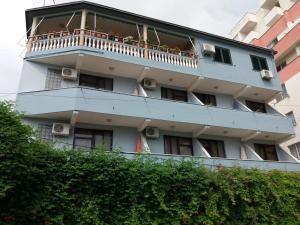 a building with a balcony with flowers on it at Arben in Durrës