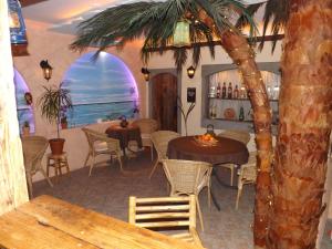 a restaurant with tables and chairs and a palm tree at Haus Oberkassel in Bonn