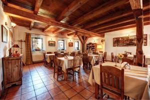 a restaurant with tables and chairs in a room at Ślężański Młyn in Szczepanów