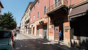a man walking down a street next to a building at Hostel Antique in Pula