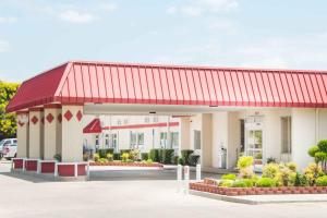 a gas station with a red roof at Ramada by Wyndham Enid in Enid