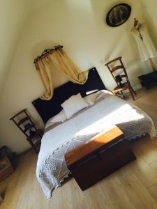 a bedroom with a bed and two chairs at La Romanée in Sallaumines