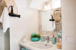 a bathroom with a sink and a mirror at Iannet & Co. in Locorotondo