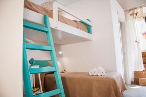 a green bunk bed in a small room with a bed at Iannet & Co. in Locorotondo
