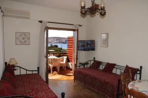 a living room with a couch and a table with a view at Ekavi Apartments in Sitia