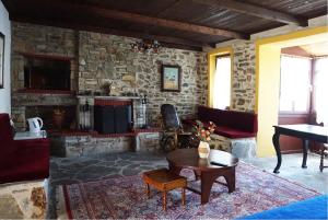 a living room with a stone wall at Akontisma in Nea Karvali