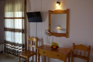 a dining room with a table and a mirror at Geroulis Stefanos Studios in Vasiliki