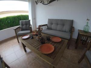 a living room with a couch and a table at Chalet Bri in Peniscola
