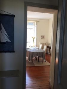 a dining room with a table and a room with a dining roomiasm at ville Pépin in Saint Malo +15 photos