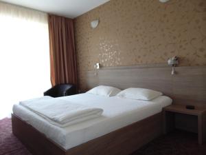 Postel nebo postele na pokoji v ubytování Hotel Holiday