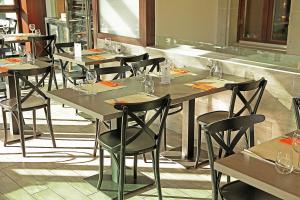 a row of tables and chairs in a restaurant at Galion Hôtel & Restaurant in Lausanne