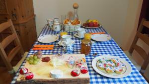 una mesa con un mantel azul y blanco con comida. en BnB Ernesto Langwies - NOT Davos, en Langwies