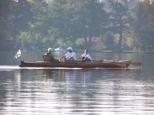 a group of people sitting in a boat on the water at Ferien in Himmelpfort in Himmelpfort