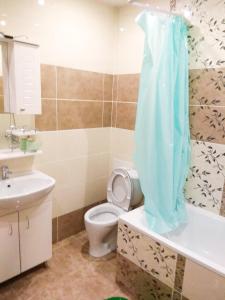 a bathroom with a toilet and a sink at Apartment Lukina 6 in Cheboksary