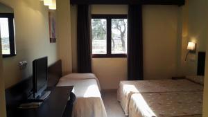 Кровать или кровати в номере Hotel Tudanca-Aranda II