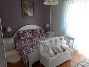 a small bedroom with a bed and a window at House Villa Mare in Malinska