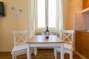 a table with two chairs and a bottle of wine at Villa Benic in Dubrovnik