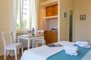 a room with two beds and a table and a kitchen at Villa Benic in Dubrovnik