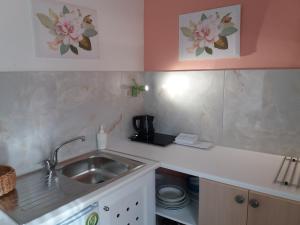 a kitchen with a sink and a counter top at Stylish Studios in Moírai