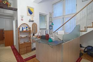 a kitchen area with a sink and a stair case at Hostel Residence in Sarajevo