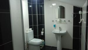 a bathroom with a toilet and a sink at Grand Ece Hotel in Canakkale