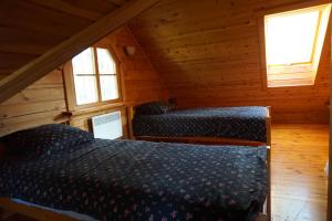 a bedroom with two beds in a cabin at Retumi in Alūksne