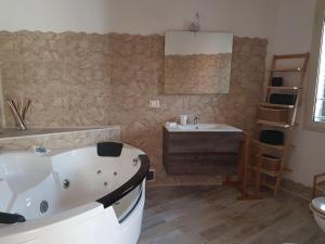 a bathroom with a bath tub and a sink at La Porta dell'Alcantara in Gaggi +124 photos