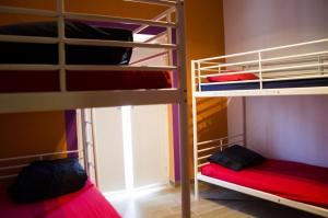 two bunk beds in a room with a window at Cloud 9 Hostel in Lagos