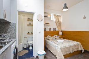 a bathroom with a bed and a toilet in a room at Host Wise - Cozy Quiet Flat - Trindade Station in Porto +12 photos