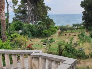 a view of a garden with the ocean in the background at Apartment Lju on the Beach in Split