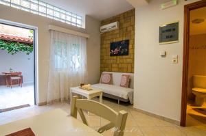 a living room with a couch and a table at La Casa Del Vitsi in Palaiochora