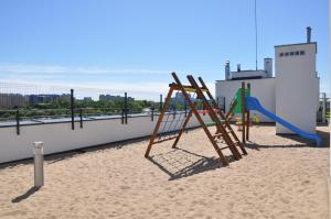a playground with a slide on a building at Apartament Zielone Tarasy in Olsztyn