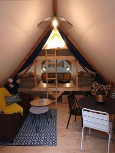 a room with a tent with tables and a light at Camping Du Port De Plaisance in Péronne