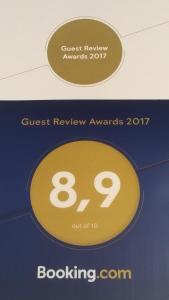 a sign that says guest review awards with the number at B&B Piazza Del Popolo in Ascoli Piceno