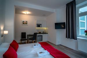 a hotel room with a bed with red pillows at Willa Tęcza in Szczawnica