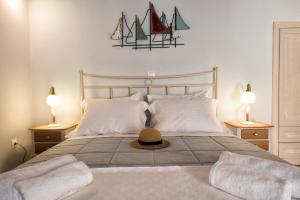 1 dormitorio con 1 cama con sombrero en Gavrion's Nest - Premium Cycladic Studio, en Gavrion