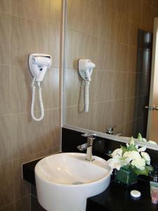 a bathroom with a sink and two phones on the wall at Sunway Lost World Hotel in Ipoh